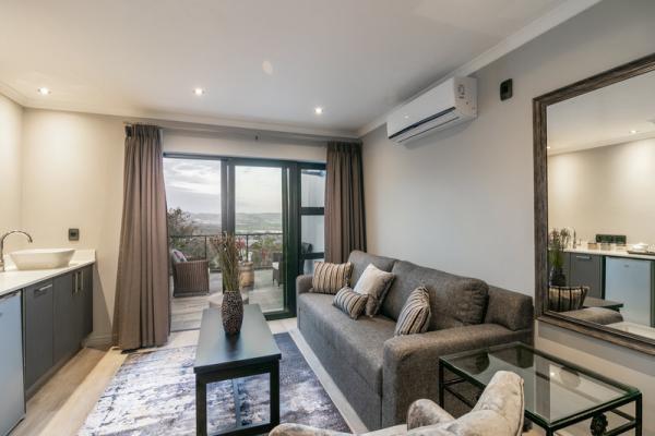 Sitting area of room with lagoon and pool view