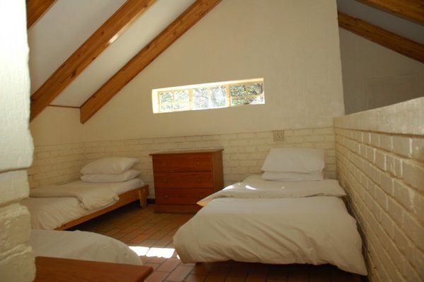 Loft room with 3 single beds.
