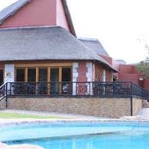 Swimming pool with restaurant at the back