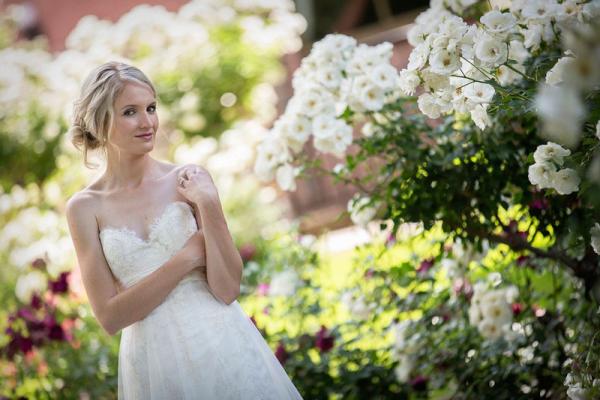 Bride in garden surrounded by roses