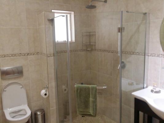 En suite bathroom with shower and bath