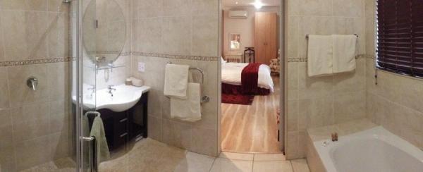 En suite bathroom with shower and bath